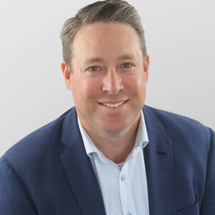 Headshot of advisor Bill Flowers, wearing a blue blazer and light blue buttoned shirt